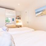 Bedroom with double bed, closet, and wall picture.