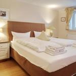 Bedroom with double bed, nightstand, and window.