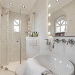 Bathroom with shower, bathtub, and mirror