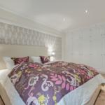 Bedroom with bed, nightstand, and closet