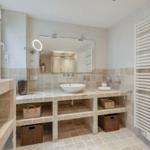 Bathroom with sink, mirror, and radiator