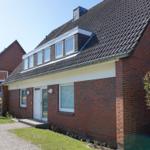 Red brick house with roof windows and front garden