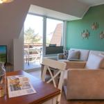 Living room with sofa, table, and balcony view.