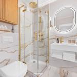 Bathroom with shower, sink, and toilet. Marble wall and gold accents.
