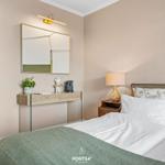 Bedroom with bed, nightstand, and mirror cabinet