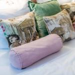 Headboard with pillows in various colors and patterns.