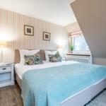 Bedroom with bed, nightstand, and window