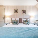 Bedroom with bed, nightstands, and window