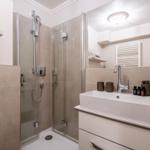 Bathroom with shower, sink, and mirror