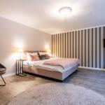 Bedroom with bed, TV, and chair