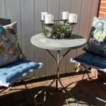 Two chairs with cushions and table on terrace