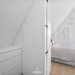 Bedroom with sloped ceiling, bed, and dresser