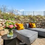 Outdoor terrace with cushions and floral arrangement