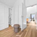 Bedroom with white closet and wooden floor. Corridor to living area with window.