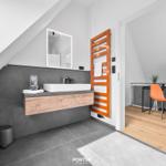 Bathroom with shower, mirror cabinet, and orange heater.