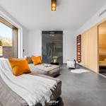 Lounge with sauna and shower. Large glass front to terrace.