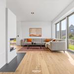 Living room with sofa, fireplace, and large window view
