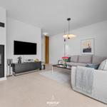 Living room with sofa, fireplace, and TV