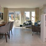 Living and dining area with seating, dining table, and glass doors to terrace.