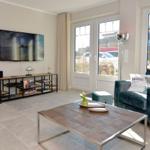 Living room with sofa, TV, and large window.