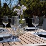 Set table with glasses and flowers in the garden
