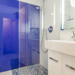 Bathroom with shower, sink, and mirror