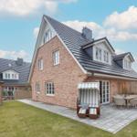 House with terrace, garden, and sun lounger. Backyard with wooden shed.