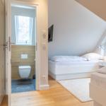 Room with two beds and attached shower