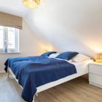 Bedroom with bed, nightstand, and window