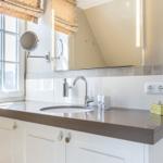 Bathroom with sink, mirror, and window