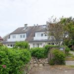 White villa with dormers and garden path