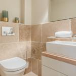 Bathroom with toilet, sink, and towel