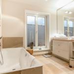 Bathroom with bathtub, sink and window