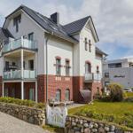 Holiday home with balconies and stone wall in the garden
