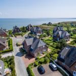 Houses with roofs and gardens by the sea
