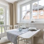 Dining table with chairs and windows to the garden