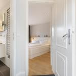 Bedroom with bed and bathroom in view
