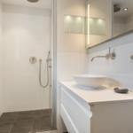 Bathroom with shower, sink, and mirror