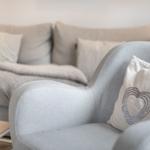 Gray seating area with cushions and blanket in living space