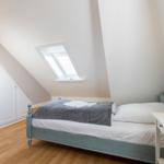 Bedroom with skylight, bed, and nightstand