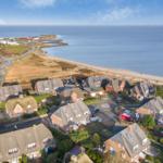 View of coastal village with houses and beach