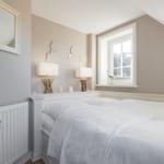 Bedroom with double bed, window, and lamps