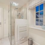 Bad mit Dusche, Fenster mit Meerblick und Heizung