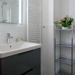 Bathroom with sink, mirror, and shelf.