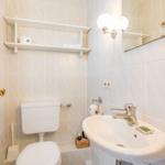Bathroom with toilet, sink, and mirror