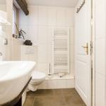 Bathroom with sink, toilet, and heater