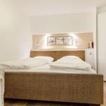 Bedroom with bed, nightstand, and closet.