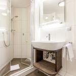 Bathroom with shower, sink, and mirror
