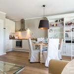 Kitchen with dining area and bookcase in the background.