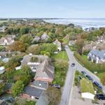 Village with thatched houses and view of the North Sea.
